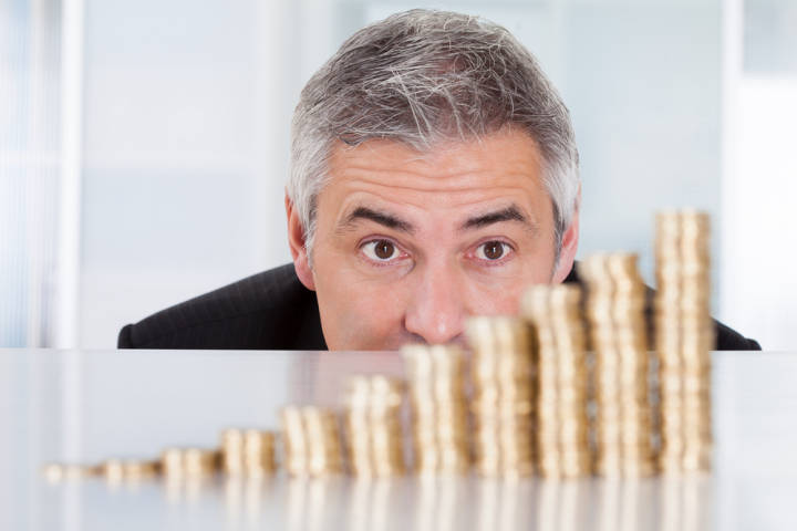 A senior looking at a pile of coins